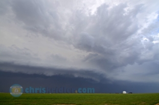 The May 29 storms in western Kansas sweep over a green field.