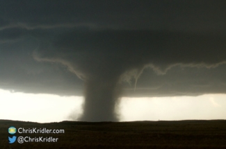 The tiny satellite funnel keeps circling the tornado.