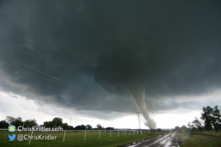 A wider shot shows the mesocyclone as the tornado tangles with power lines.