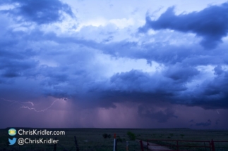 Lightning illuminates the base of the retreating supercell.