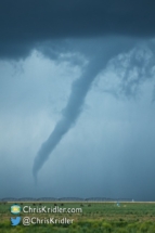 A closeup as the tornado emerges from the precipitation.