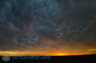 Mammatus clouds are lit by the setting sun.