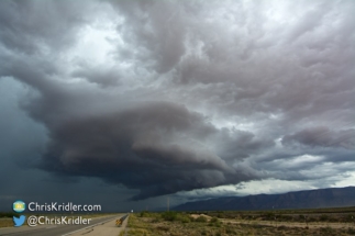 The storm kept its strength as it crossed the road.