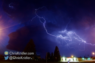 Here's one more - a bolt flanked by lens flares from the street lamps.