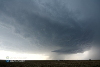 The storms bubbled. Several of my chaser friends line the road in this photo.