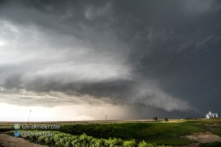 Another lowering seems to appear in the rain beneath the storm.