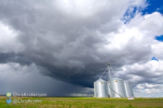 The silos gleamed under the storm.