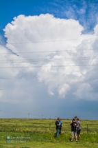 Chasers chat as a budding storm gets a mushroom-cloud appearance behind them.