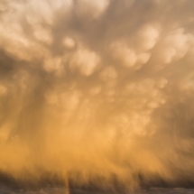 Mammatus clouds put on a dazzling show - with rainbow.