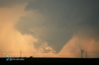 The sunset lit up the rain and the tornado.