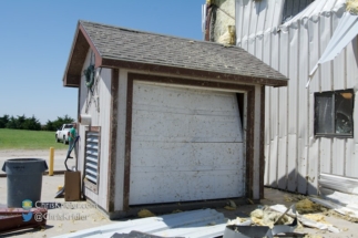 Debris had hammered this garage door.