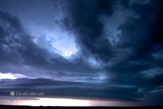 Lightning illuminates the developing striations at 2:24 a.m. CDT.