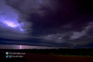 Lightning flashes in the shelf cloud a bit farther east.