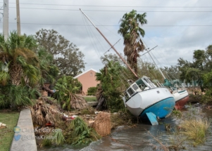 Two boats tossed against the shore in Cocoa Village.