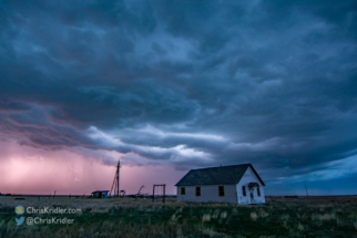 Lightning sparks in the rain as dusk descends on the storms.