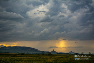 A wide shot shows a painterly sky.