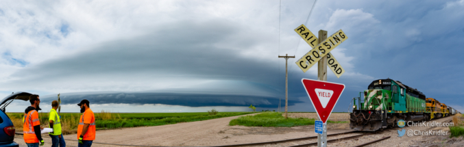 A railroad crew exchange at a crossing offered a unique framing of the storm.