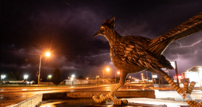 Lightning fires behind the road runner sculpture in Fort Stockton, Texas.