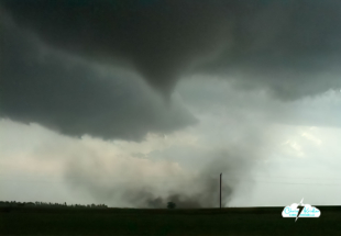 On the eastern edge of Attica, Kansas, the tornado spins up in a field with the rushing sound of a waterfall, just to our south.