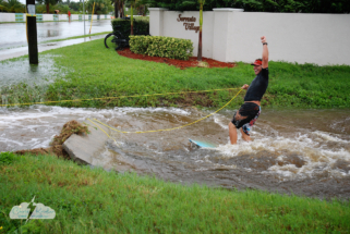 A local surfs a drainage ditch in Satellite Beach during Tropical Storm Fay.