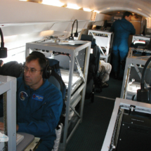 OVER THE CARIBBEAN, SEPT. 2, 2004 - Chris Landsea (foreground), a meteorologist with NOAA&#039;s Hurricane Research Division, analyzes dropsonde data as the Gulfstream IV drops the instrumented capsules around the periphery of Hurricane Frances.