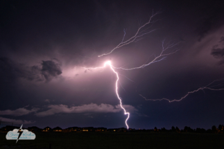 A lightning crawler shoots across the sky east of Kissimmee over a suburban neighborhood.