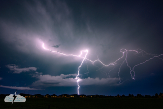 A lightning crawler shoots across the sky east of Kissimmee over a suburban neighborhood.