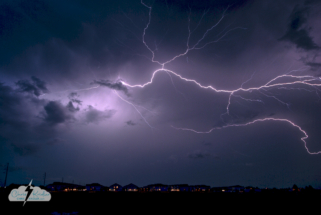 A lightning crawler shoots across the sky east of Kissimmee over a suburban neighborhood.