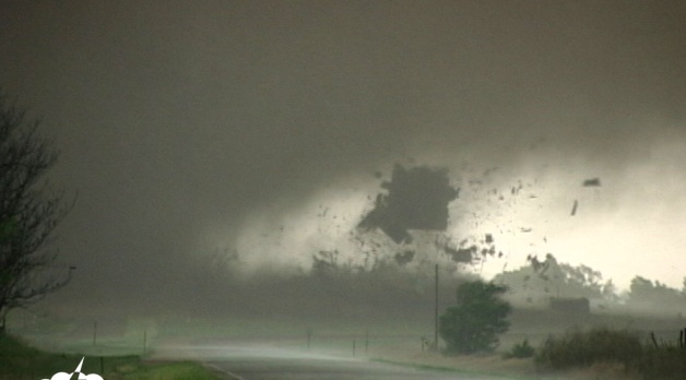 A tornado tears the roof off a house in Attica, Kansas.